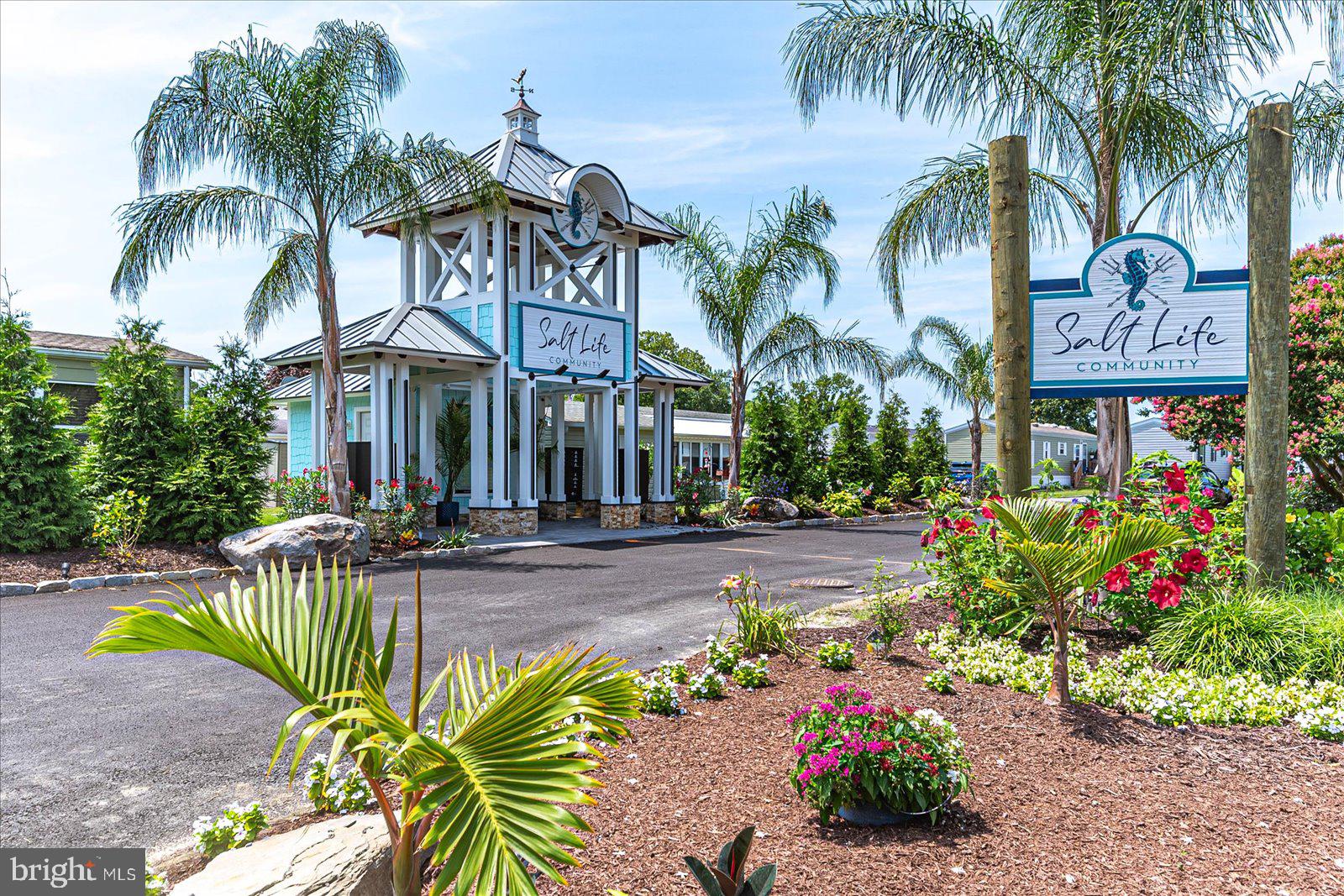 12346 Old Bridge Road, Unit 152 Ocean City, MD 21842 - Photo 44 of 55 a front view of multi story residential apartment building and car parked on street