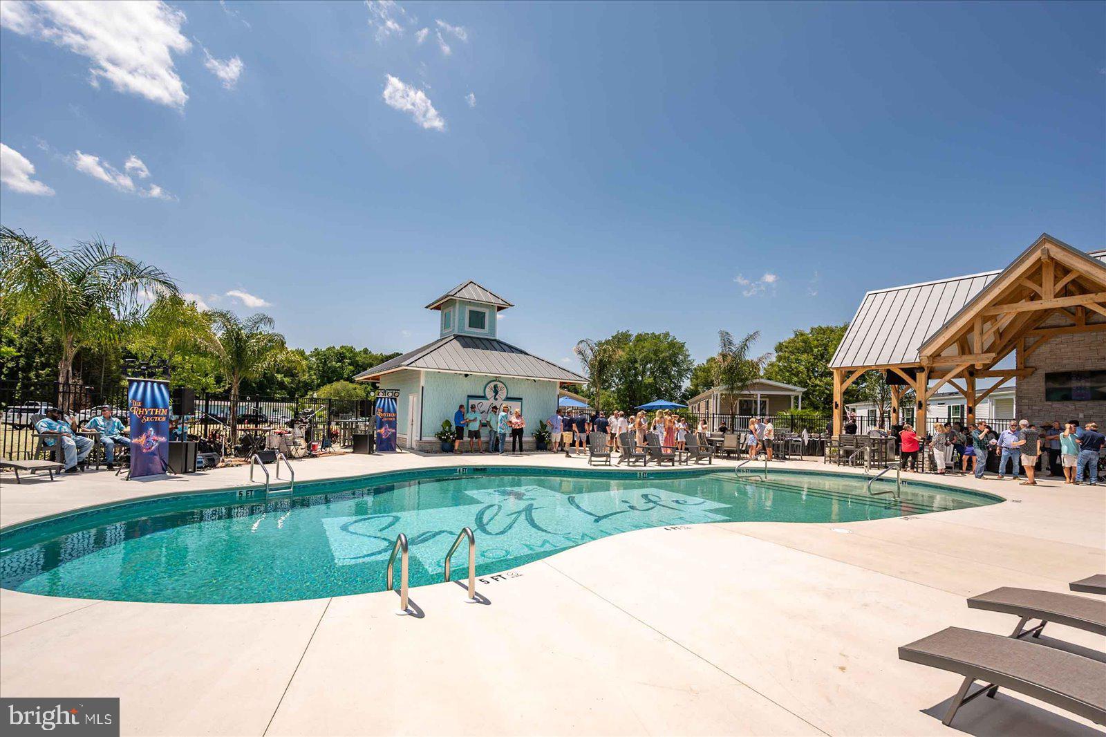 12346 Old Bridge Road, Unit 152 Ocean City, MD 21842 - Photo 46 of 55 a view of a house with a yard and sitting area