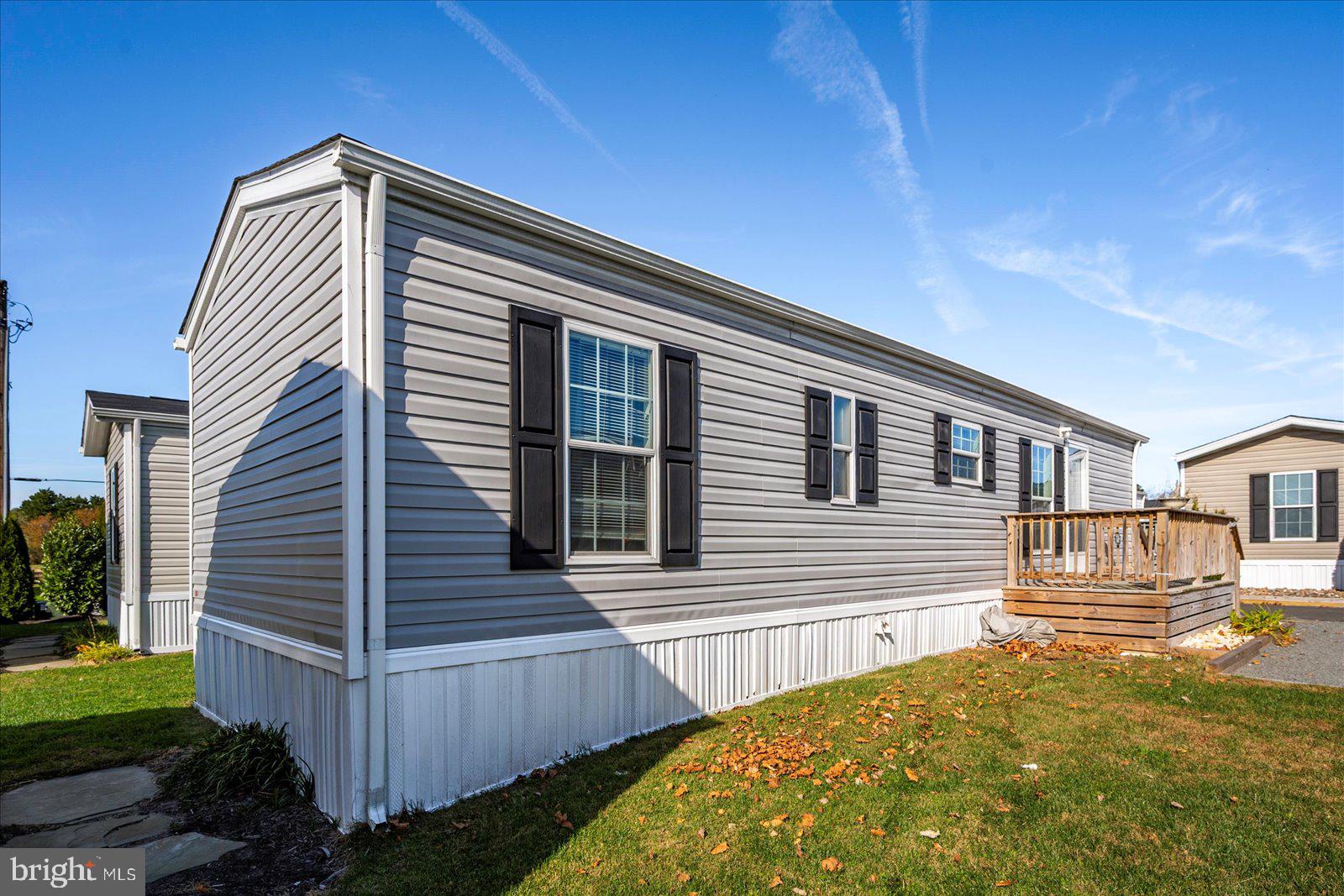 12346 Old Bridge Road, Unit 152 Ocean City, MD 21842 - Photo 5 of 55 a view of house with backyard and trees in the background
