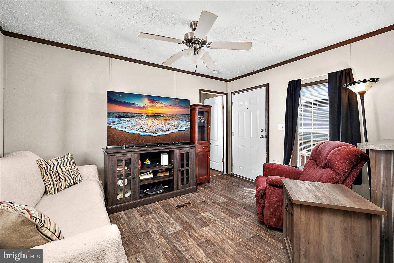 12346 Old Bridge Road, Unit 152 Ocean City, MD 21842 - Photo 7 of 55 a living room with furniture and a flat screen tv