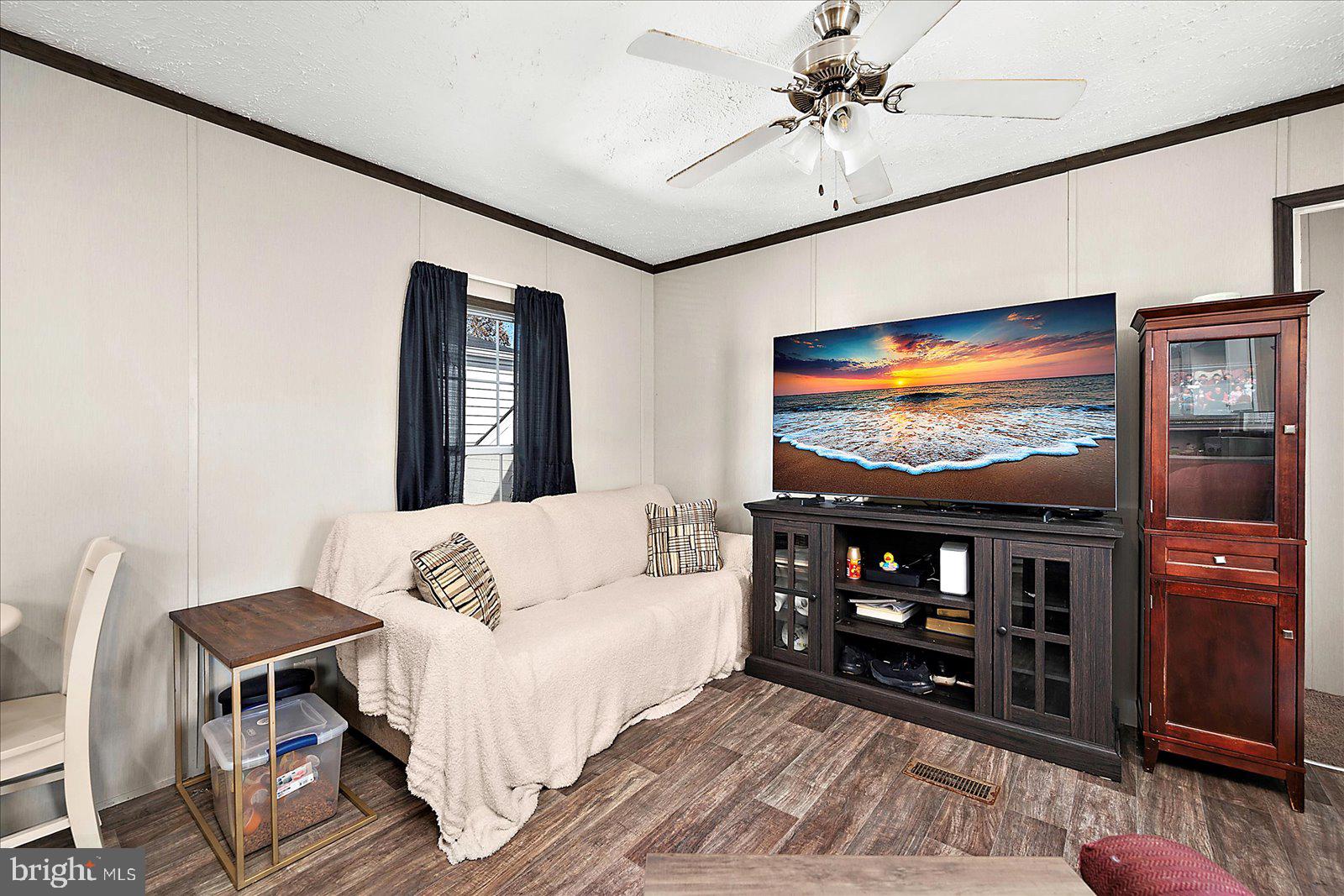 12346 Old Bridge Road, Unit 152 Ocean City, MD 21842 - Photo 9 of 55 a living room with furniture and a flat screen tv