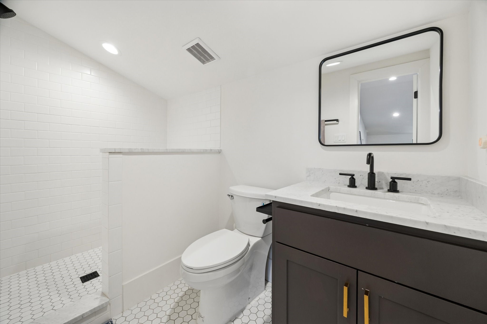 701 Ridge Street Houston, TX 77009 - Photo 41 of 50 a bathroom with a granite countertop sink mirror a toilet and a mirror