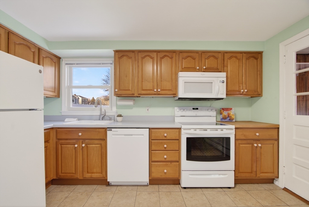 12 Patricia Road Peabody, MA 01960 - Photo 15 of 42 a kitchen with a white stove top oven and refrigerator