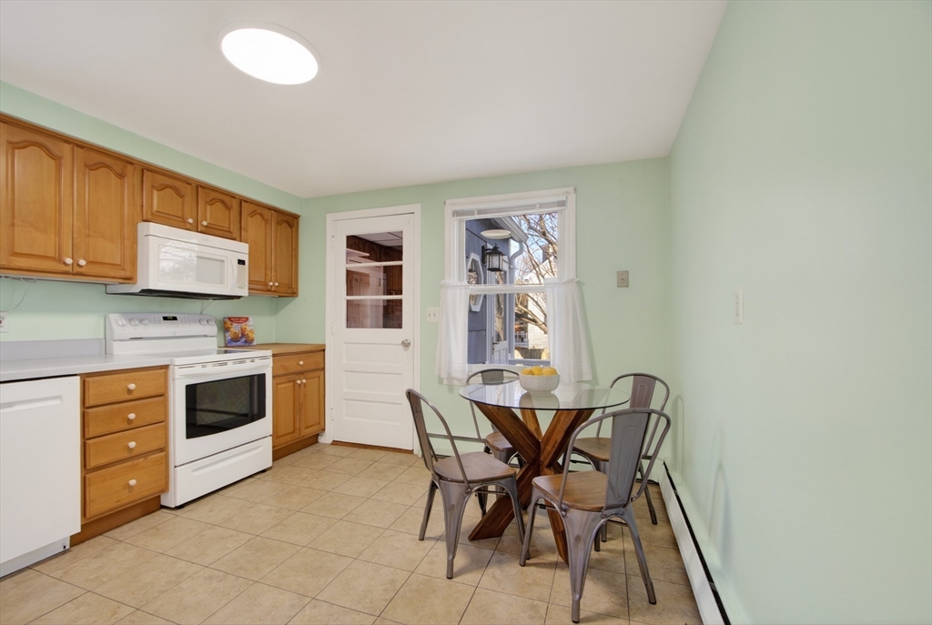 12 Patricia Road Peabody, MA 01960 - Photo 16 of 42 a kitchen with stainless steel appliances a stove a sink cabinets and a window