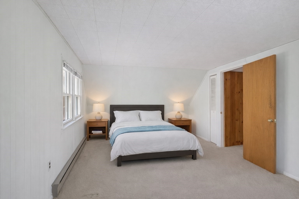 12 Patricia Road Peabody, MA 01960 - Photo 21 of 42 a bedroom with a bed lamp and a window