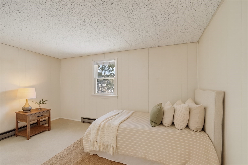 12 Patricia Road Peabody, MA 01960 - Photo 24 of 42 a bedroom with a bed and a lamp on dresser