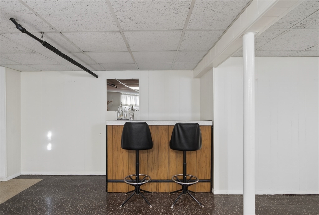 12 Patricia Road Peabody, MA 01960 - Photo 33 of 42 a view of an empty room with wooden floor and cabinets