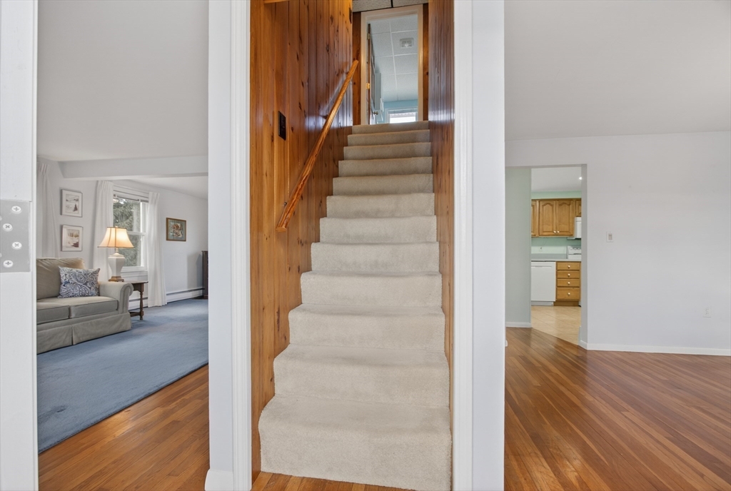 12 Patricia Road Peabody, MA 01960 - Photo 6 of 42 a view of a hallway view with wooden floor and staircase