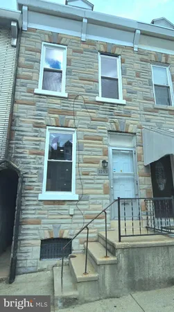 a view of a brick house with many windows