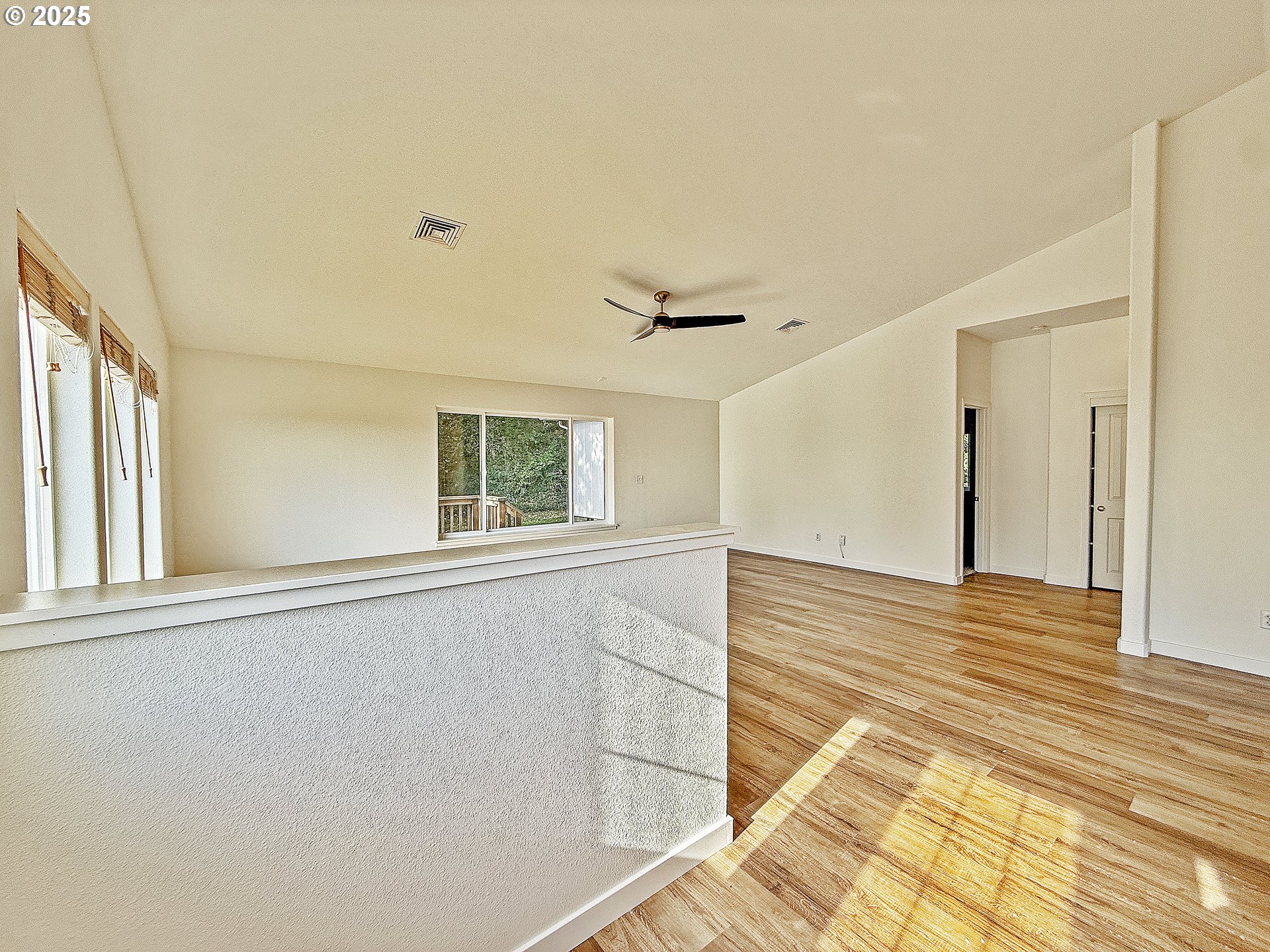 97923 Payne Road Brookings, OR 97415 - Photo 17 of 42 a view of an empty room with wooden floor and a window