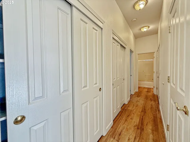a view of a hallway with wooden floor