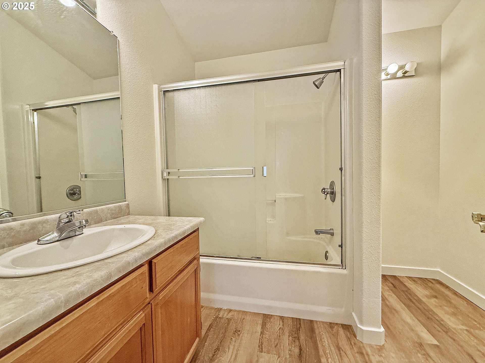 97923 Payne Road Brookings, OR 97415 - Photo 32 of 42 a bathroom with a granite countertop sink a mirror a bathtub and shower