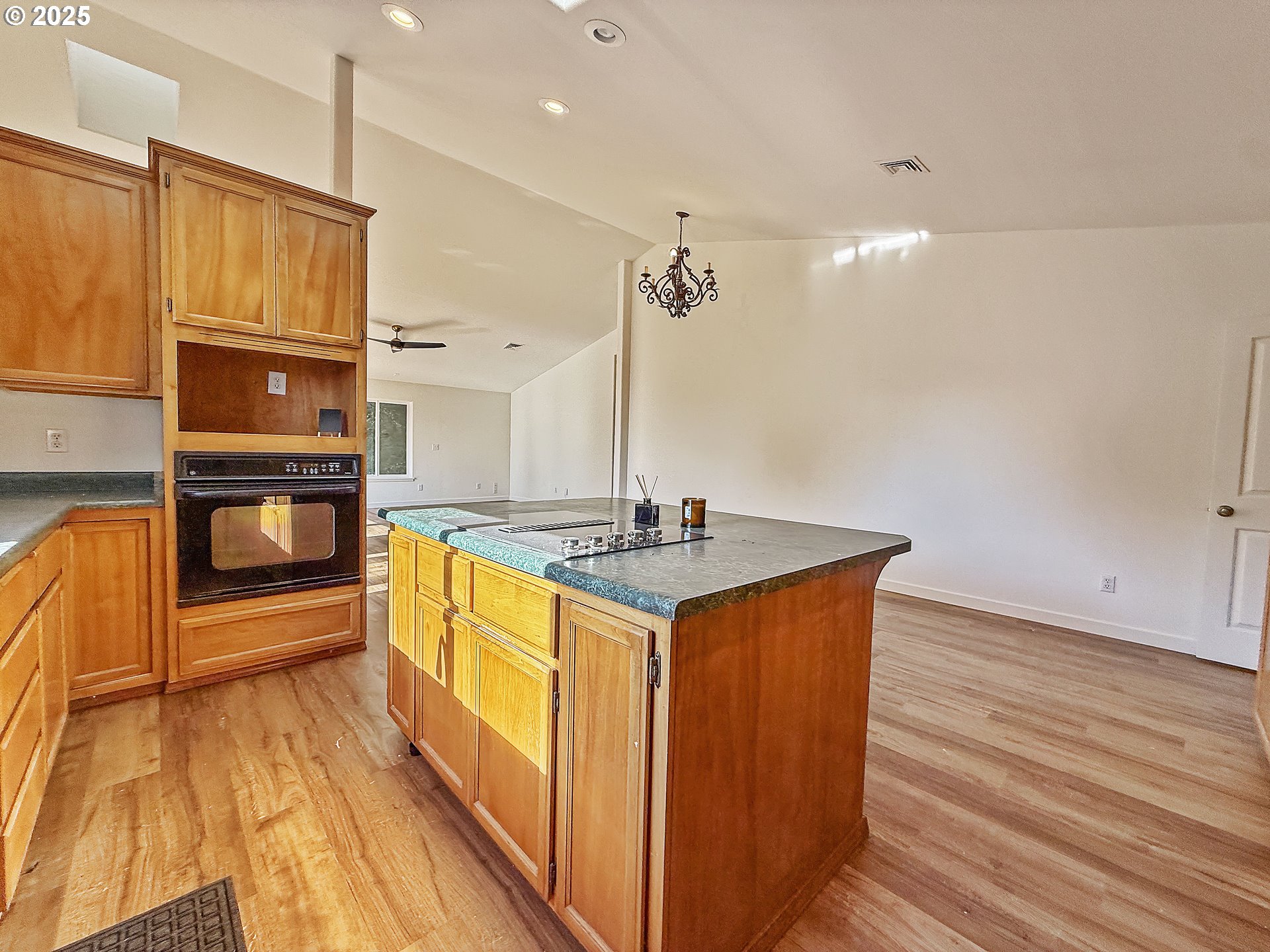 97923 Payne Road Brookings, OR 97415 - Photo 38 of 42 a kitchen with stainless steel appliances granite countertop a sink a stove and a wooden floors