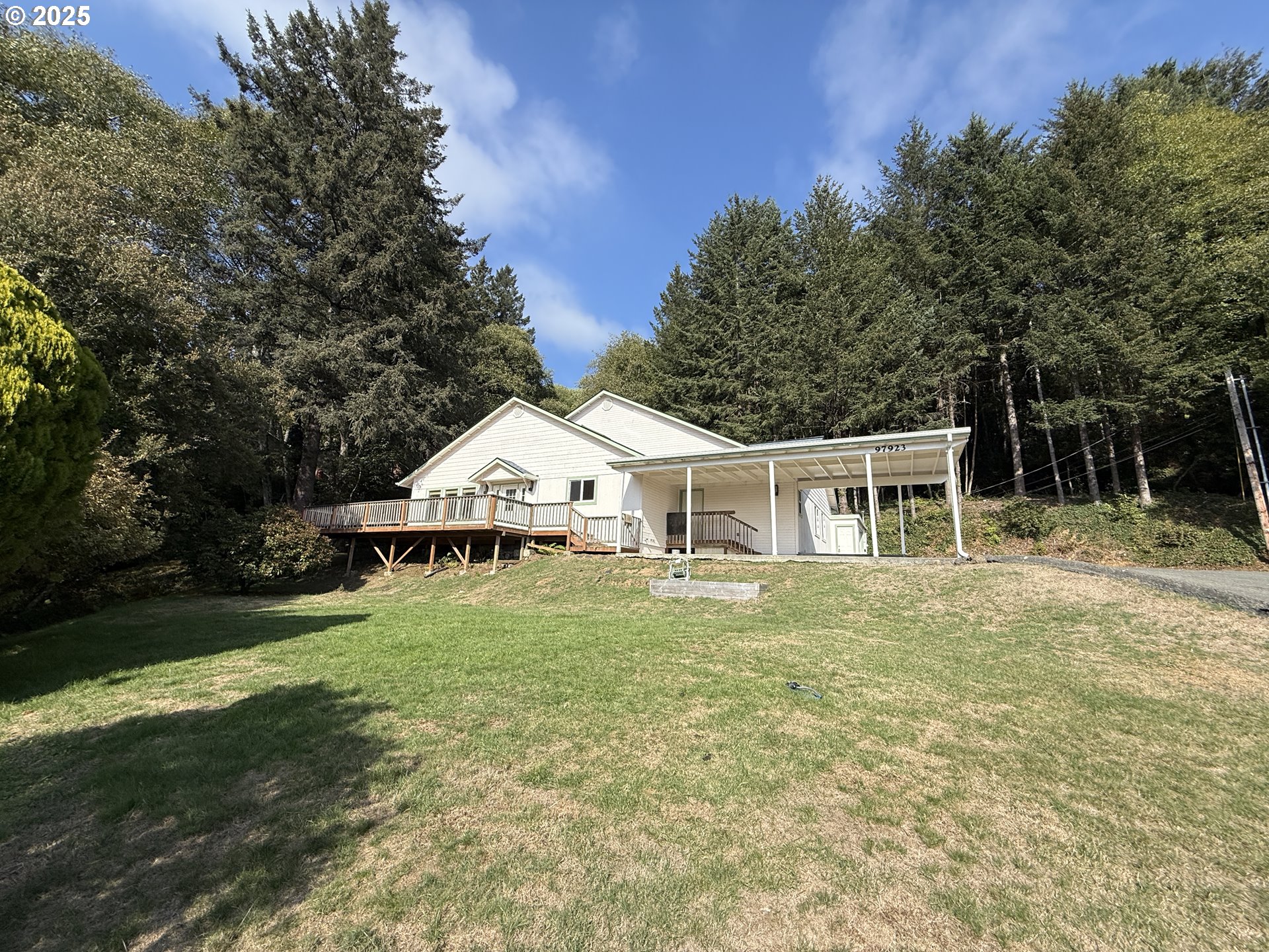 97923 Payne Road Brookings, OR 97415 - Photo 41 of 42 a white house with a big yard and large trees