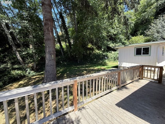 97923 Payne Road Brookings, OR 97415 - Photo 5 of 42 a view of a wooden deck and a yard with wooden fence