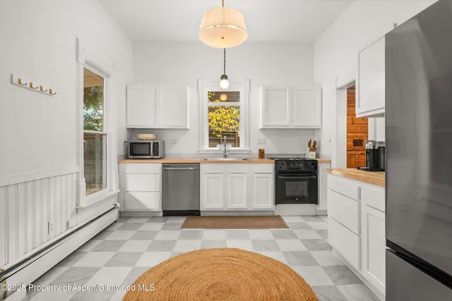 a kitchen with a stove a sink and a refrigerator