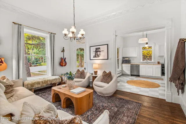 a living room with furniture and a chandelier