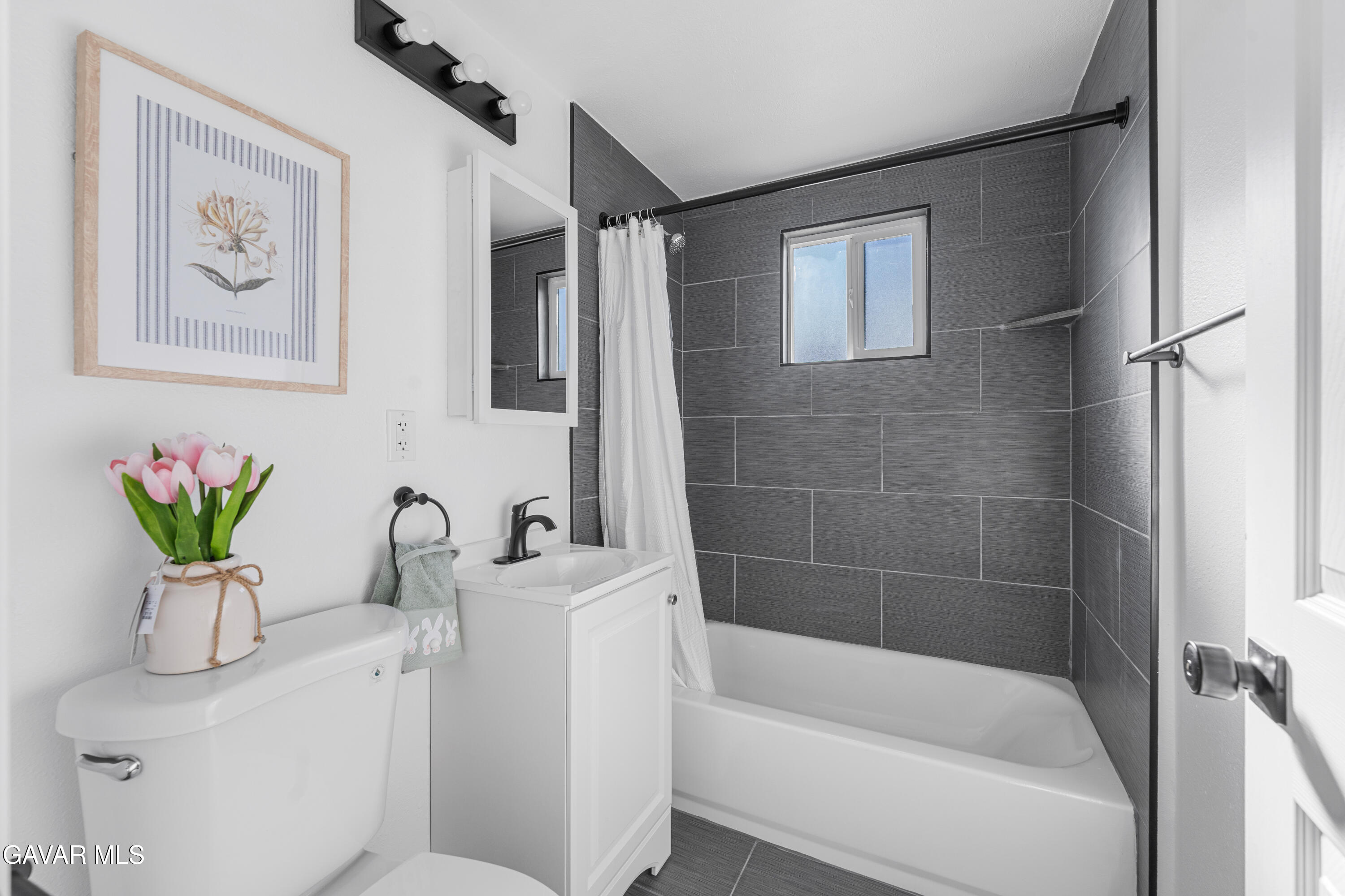 44745 3rd Street East Lancaster, CA 93535 - Photo 12 of 30 a bathroom with a sink a bathtub and a shower