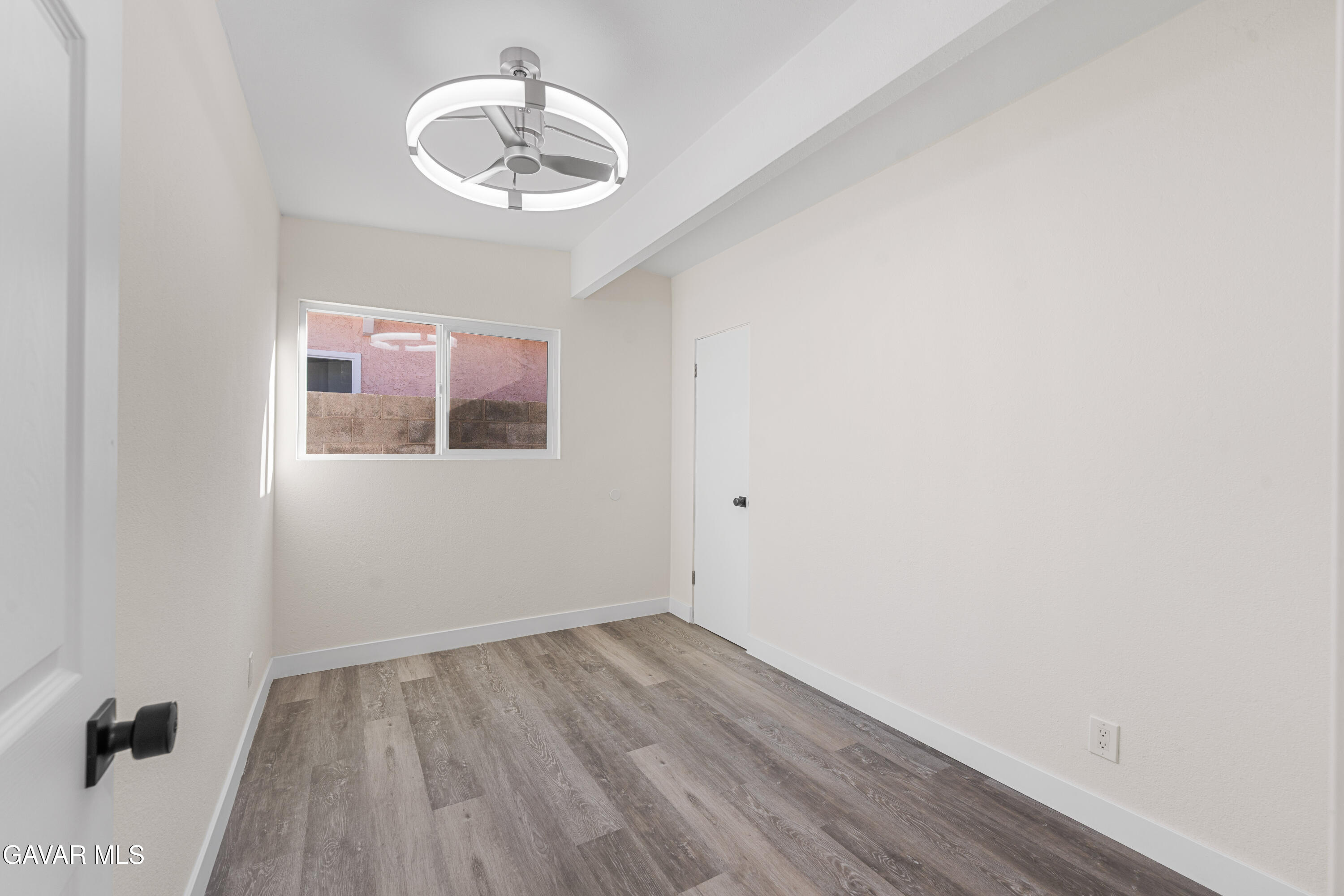 44745 3rd Street East Lancaster, CA 93535 - Photo 13 of 30 a view of an empty room with wooden floor and a window
