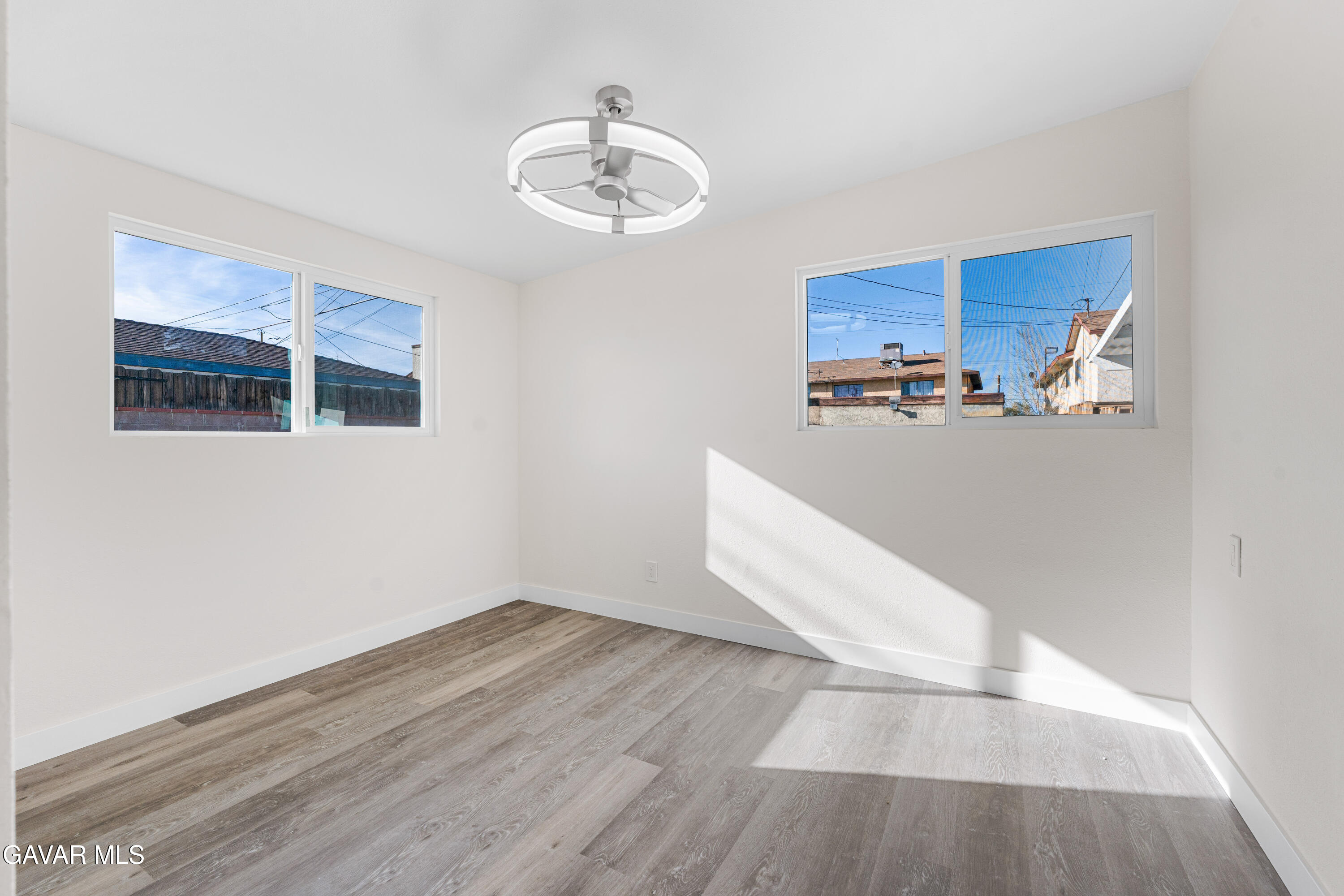 44745 3rd Street East Lancaster, CA 93535 - Photo 14 of 30 a view of a room with wooden floor and chandelier