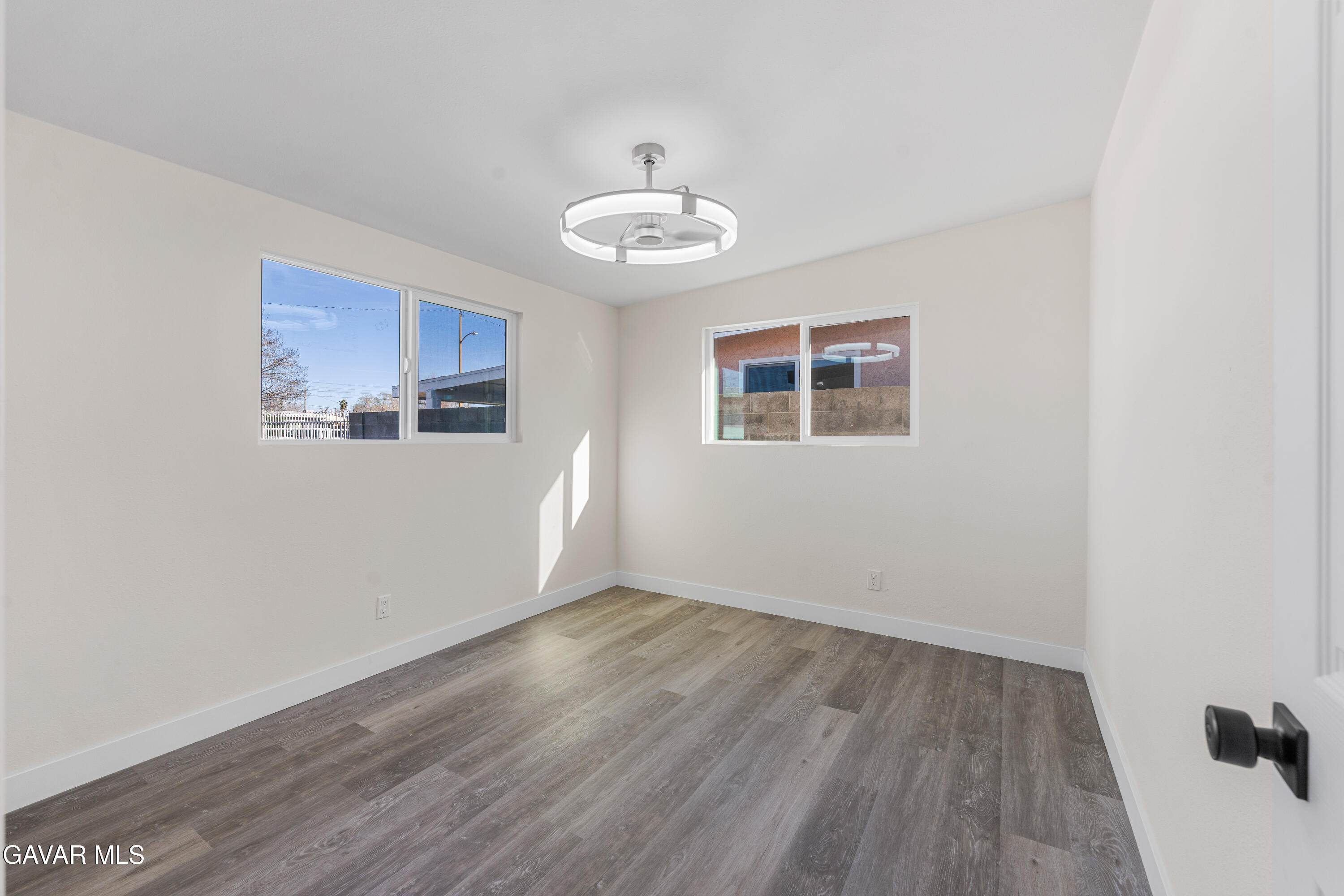 44745 3rd Street East Lancaster, CA 93535 - Photo 20 of 30 a view of an empty room with wooden floor and a window