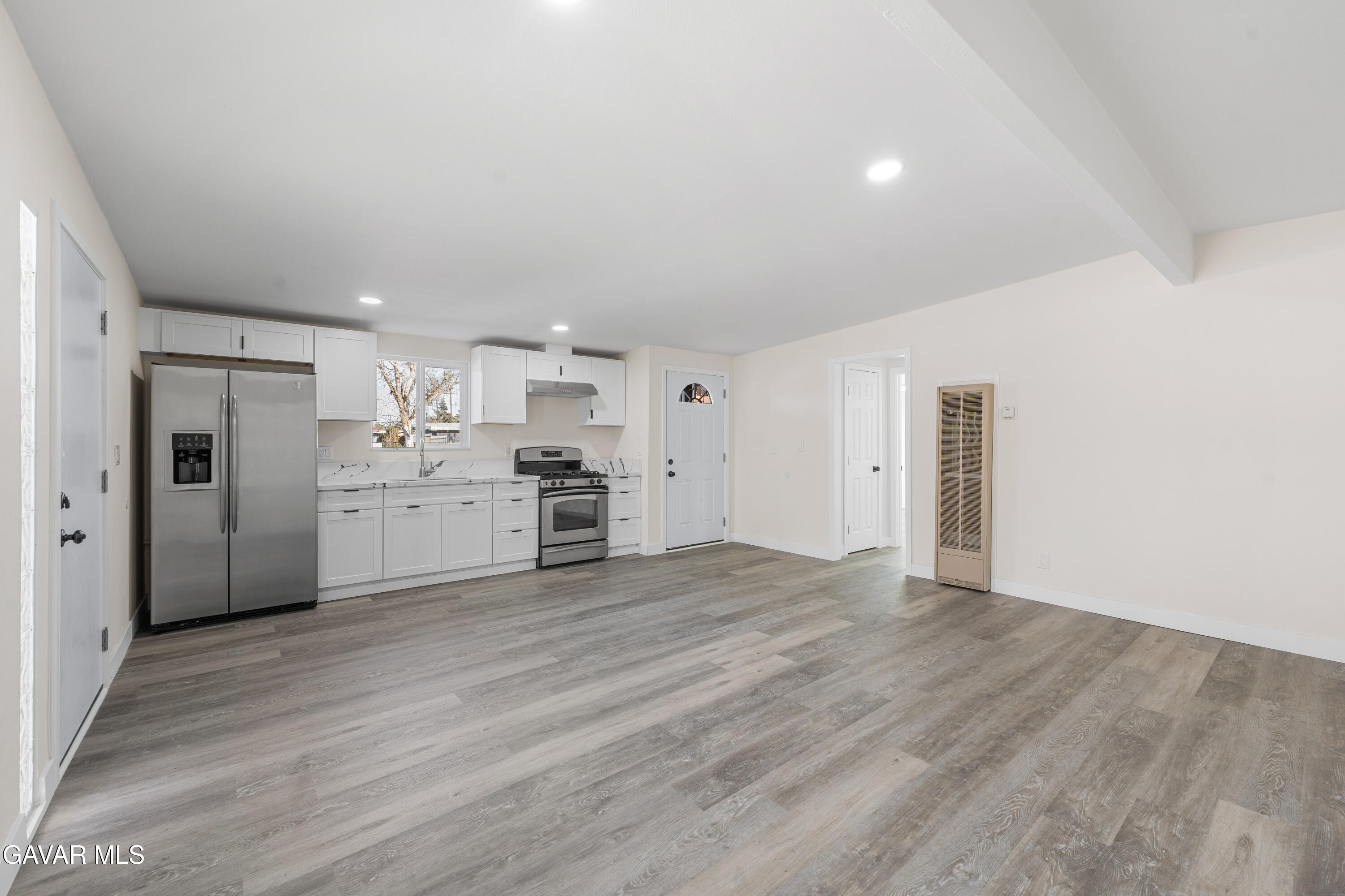 44745 3rd Street East Lancaster, CA 93535 - Photo 23 of 30 a view of a kitchen with refrigerator and white cabinets