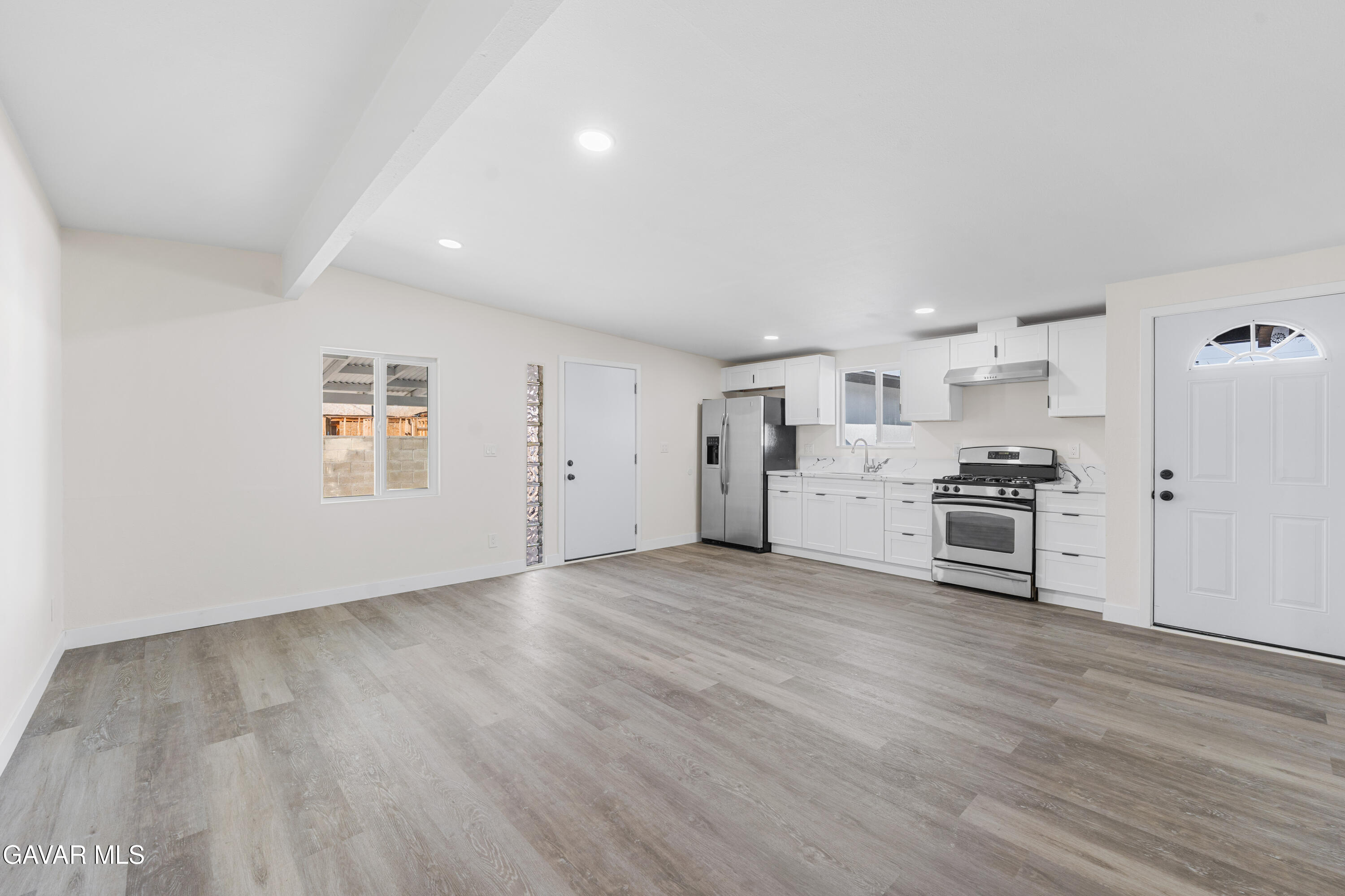 44745 3rd Street East Lancaster, CA 93535 - Photo 25 of 30 a view of kitchen with wooden floor and electronic appliances