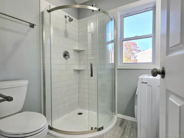a bathroom with a toilet and shower