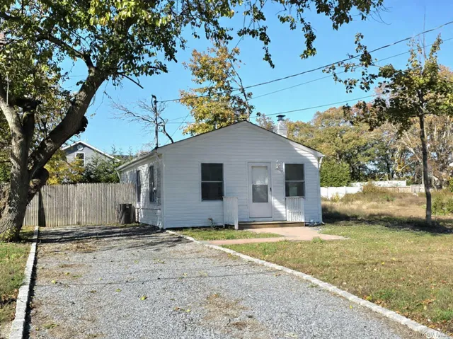 a house that has a tree in front of it