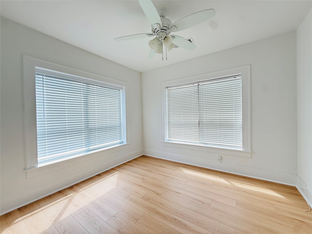 1201 West Gray Street, Unit 3 Houston, TX 77019 - Photo 6 of 10 an empty room with wooden floor and windows