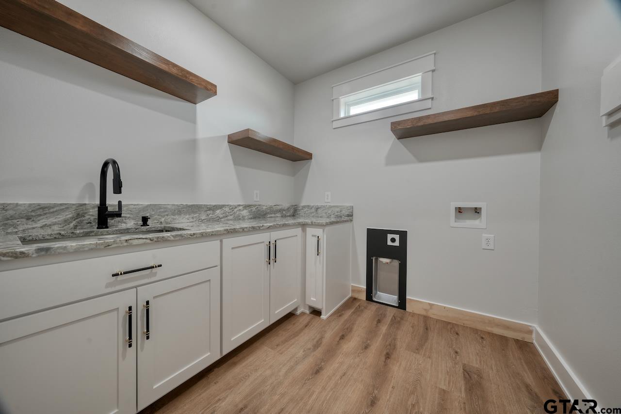 19383 Ridge Point Circle Lindale, TX 75771 - Photo 21 of 48 a kitchen with granite countertop white cabinets and white appliances