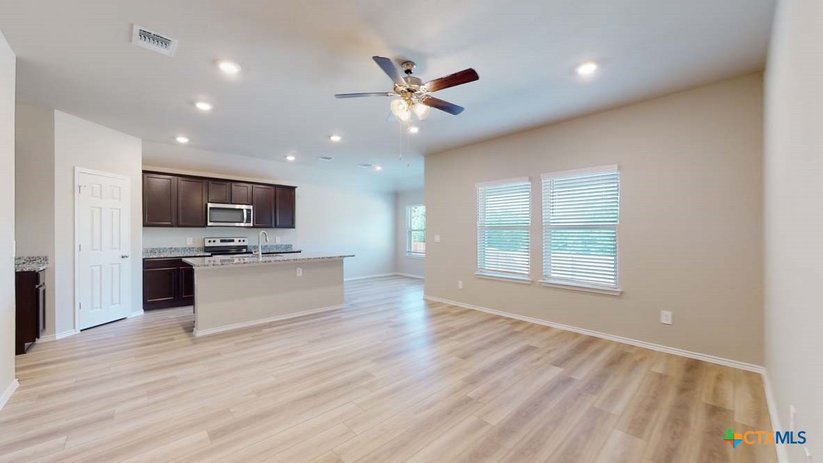 549 Hector Loop Georgetown, TX 78626 - Photo 9 of 22 a view of a kitchen with microwave and stove