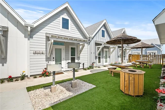 a front view of house with yard patio and outdoor seating