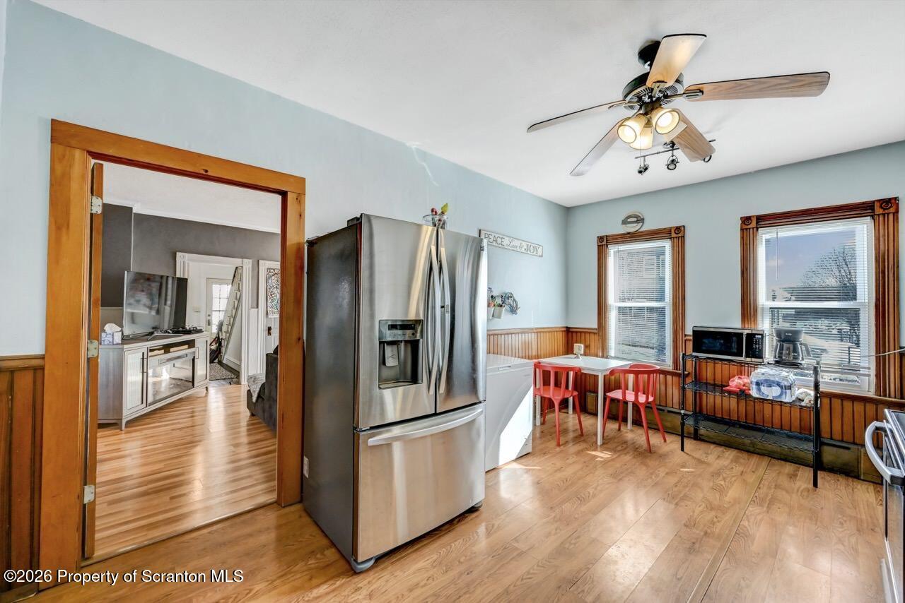 117 West Line Street Olyphant, PA 18447 - Photo 14 of 47 a kitchen with stainless steel appliances granite countertop a refrigerator a stove and a dining table with wooden floor