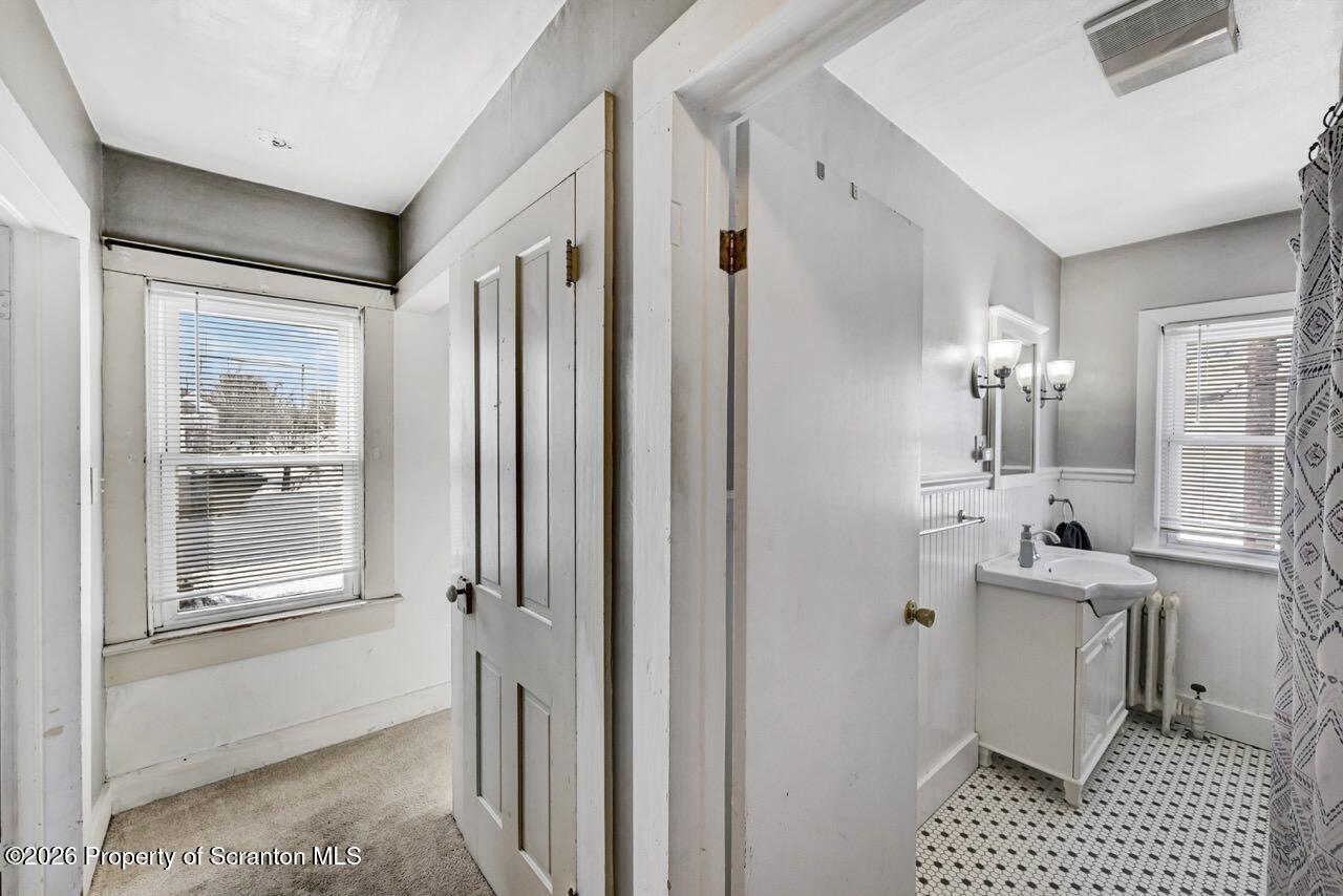 117 West Line Street Olyphant, PA 18447 - Photo 36 of 47 a bathroom with a sink a toilet a mirror and shower