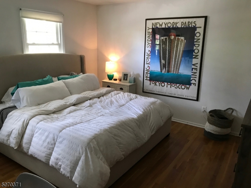 18 Parrott Mill Road Chatham, NJ 07928 - Photo 12 of 19 a bedroom with a bed and a painting on the wall