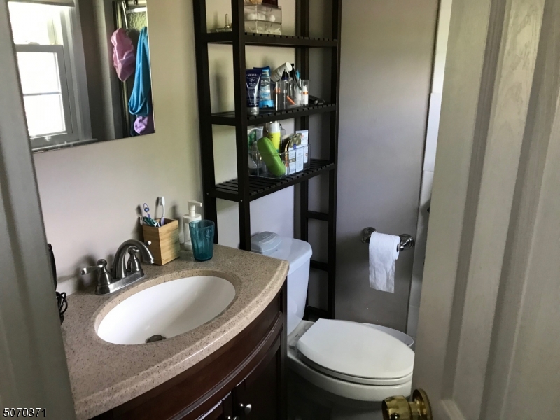 18 Parrott Mill Road Chatham, NJ 07928 - Photo 13 of 19 a bathroom with a granite countertop toilet sink and mirror
