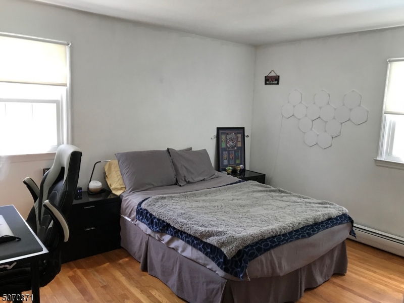 18 Parrott Mill Road Chatham, NJ 07928 - Photo 16 of 19 a bedroom with a bed and wooden floor