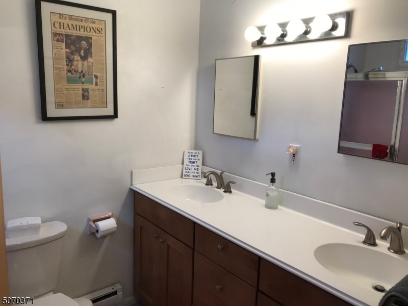 18 Parrott Mill Road Chatham, NJ 07928 - Photo 17 of 19 a bathroom with a toilet sink and mirror
