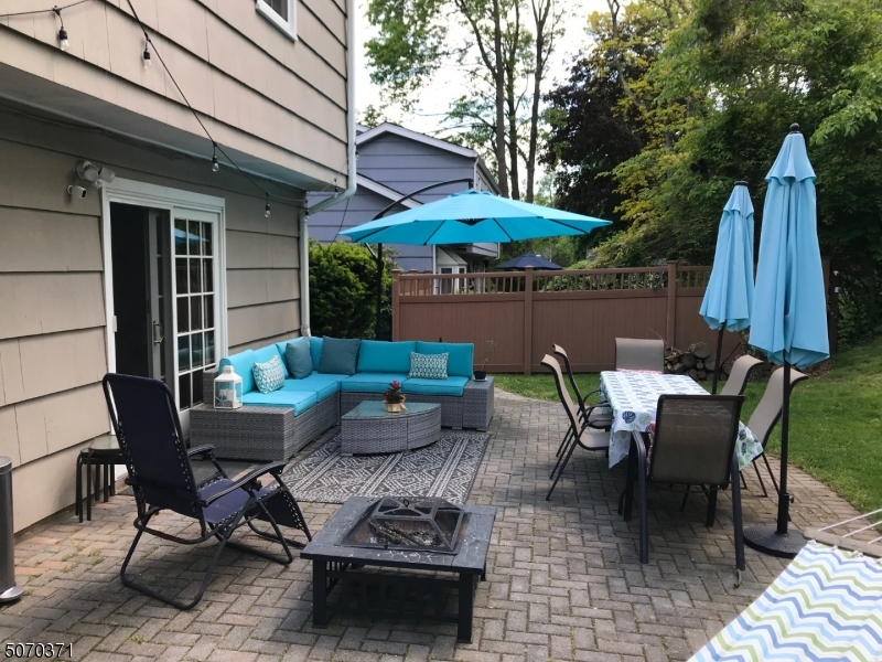18 Parrott Mill Road Chatham, NJ 07928 - Photo 18 of 19 a backyard of a house with table and chairs