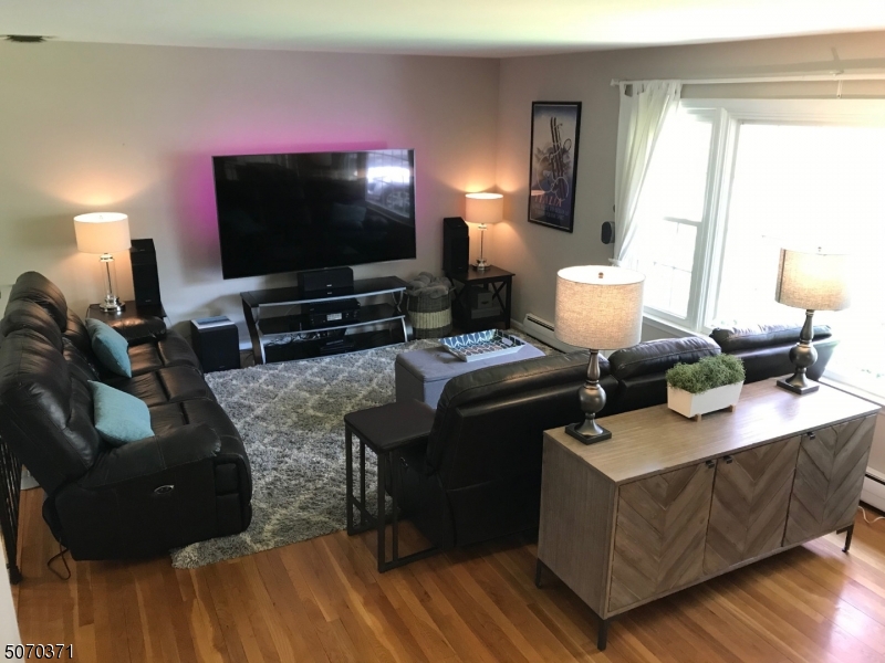 18 Parrott Mill Road Chatham, NJ 07928 - Photo 4 of 19 a living room with furniture and a flat screen tv