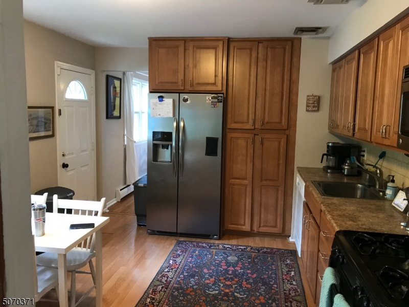 18 Parrott Mill Road Chatham, NJ 07928 - Photo 10 of 19 a kitchen with stainless steel appliances granite countertop a refrigerator and a stove