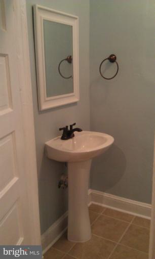 6217 York Road Baltimore, MD 21212 - Photo 9 of 20 a bathroom with a sink and mirror