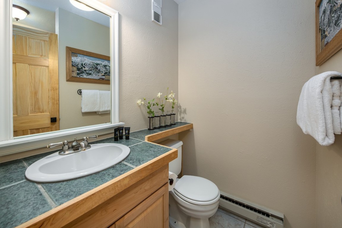 500 4 O Clock Road, Unit A22 Breckenridge, CO 80424 - Photo 11 of 16 a bathroom with a granite countertop sink and a mirror