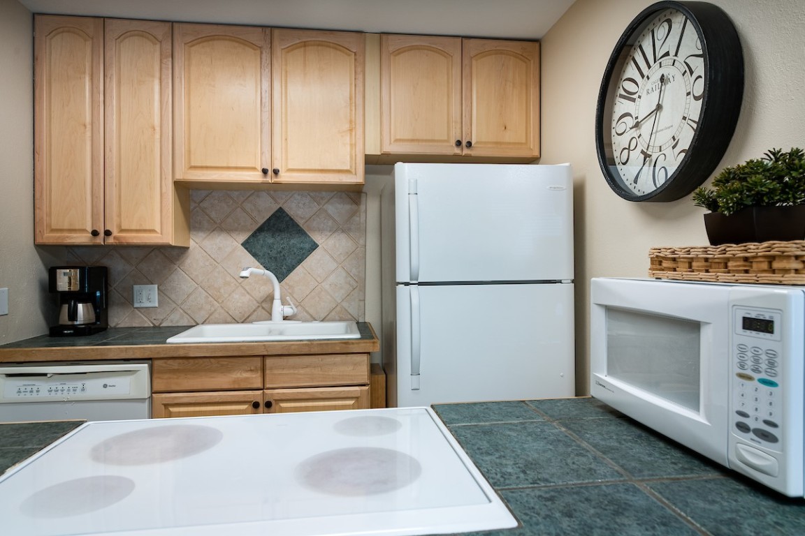 500 4 O Clock Road, Unit A22 Breckenridge, CO 80424 - Photo 8 of 16 a kitchen with stainless steel appliances granite countertop a refrigerator and a stove