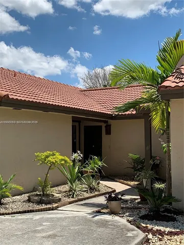 a kitchen with a refrigerator sink and cabinets