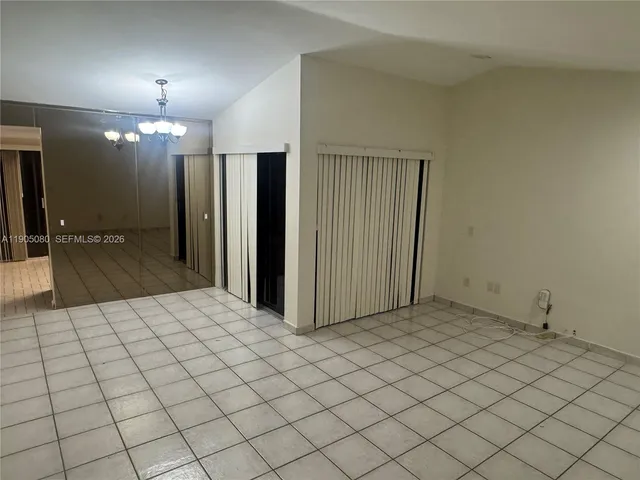 a kitchen with granite countertop a sink stove and cabinets