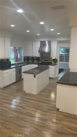 a kitchen with stainless steel appliances granite countertop a sink and a stove