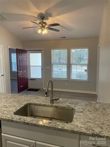 a kitchen with sink granite counter tops and window