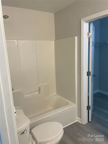 a bathroom with a toilet and a bathtub